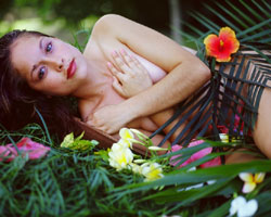 Exotic lady body wrapped in tropical plants