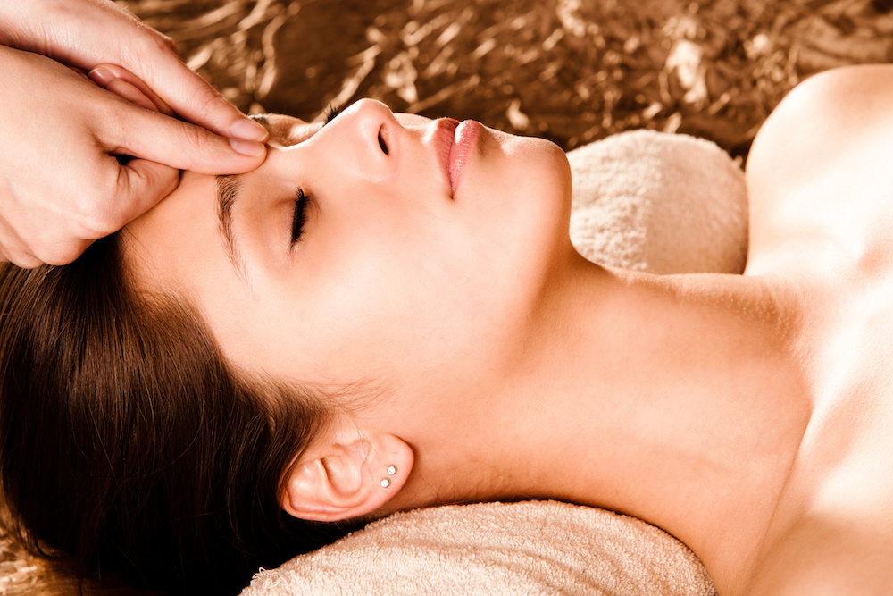 Woman receiving accupressure from registered massage therapist at the spa
